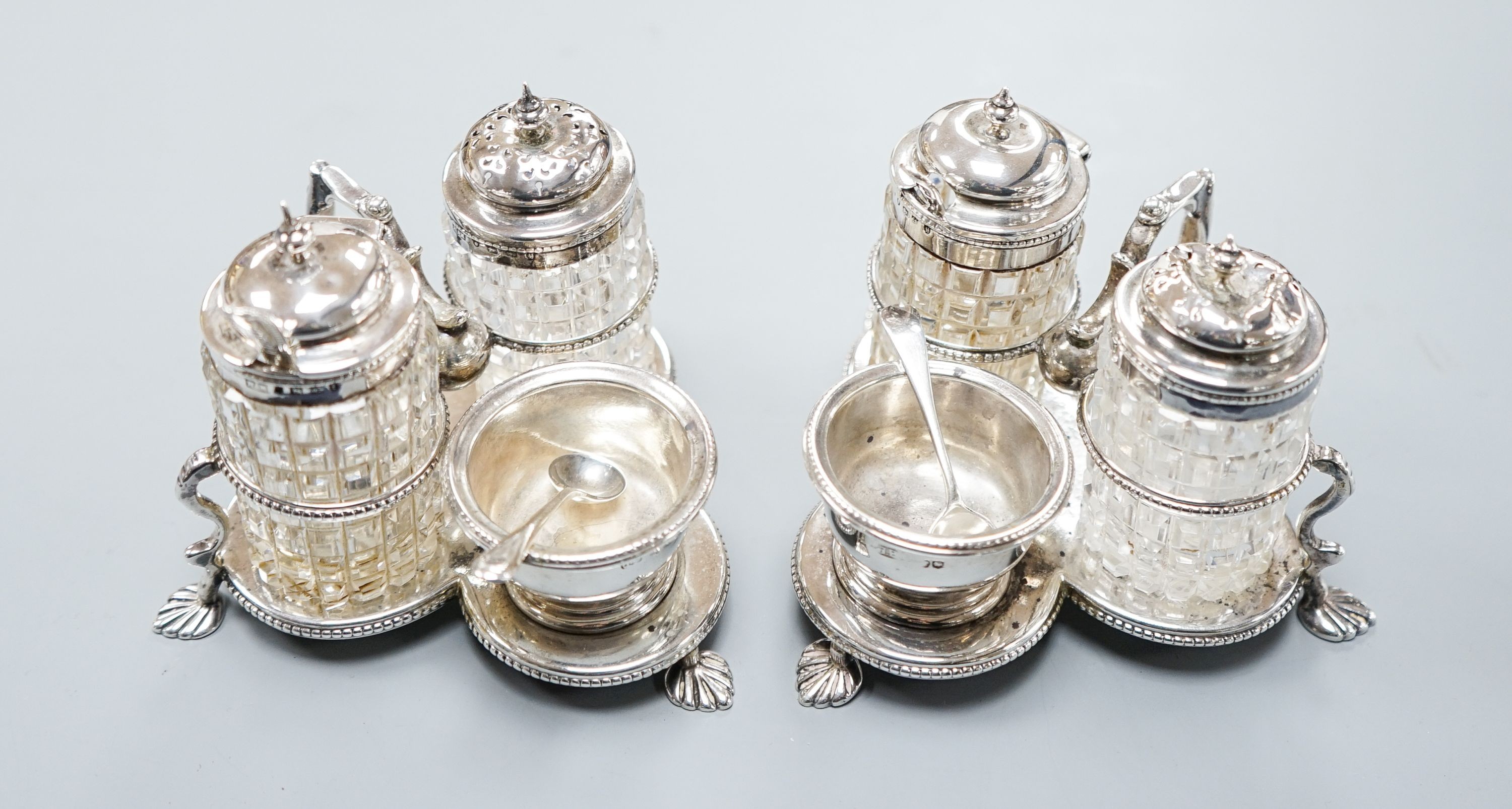 A pair of Victorian silver cruet stands, each with three cruets, Jane Brownett, London, 1880, height 85mm.